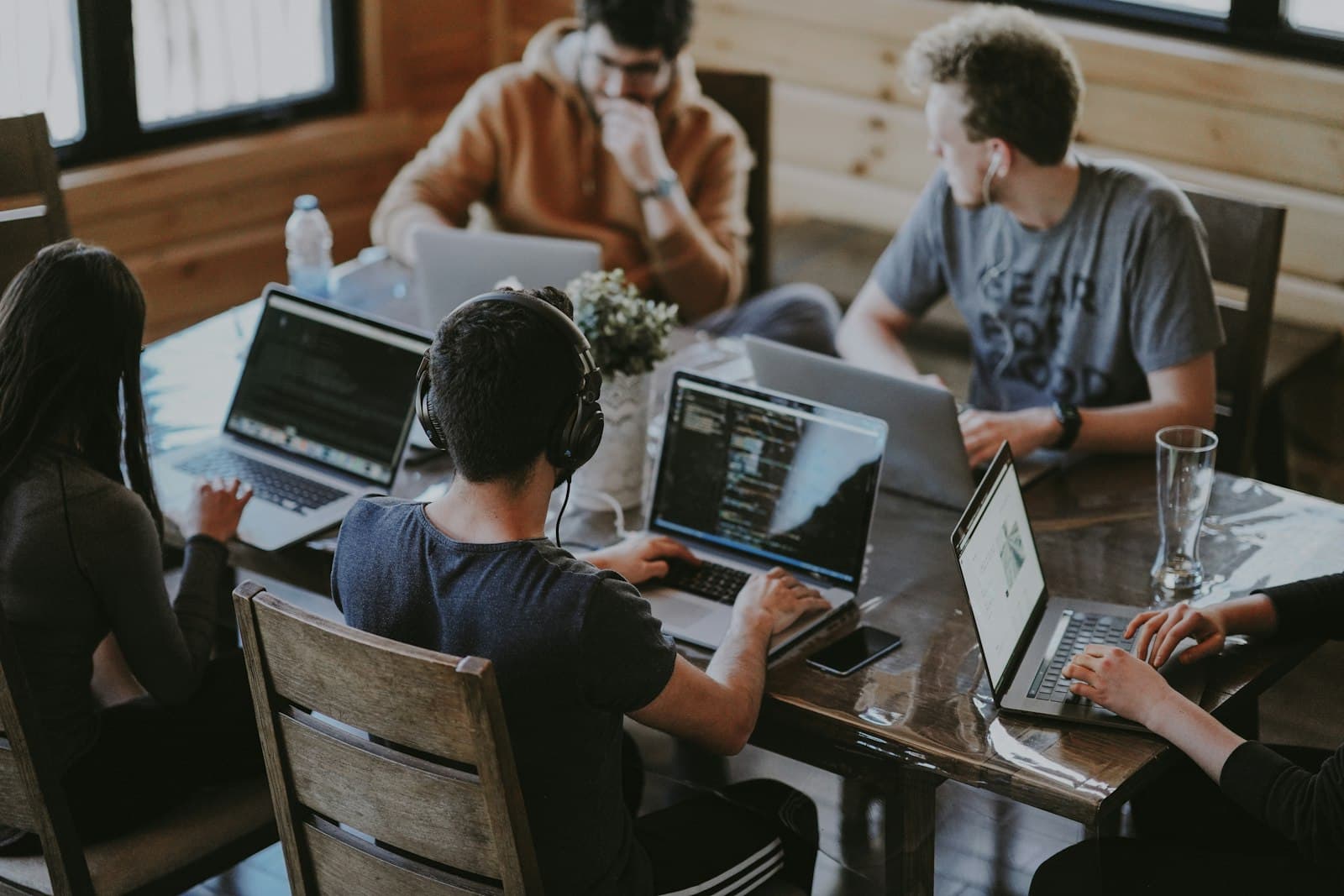 A small team collaborating around a laptop